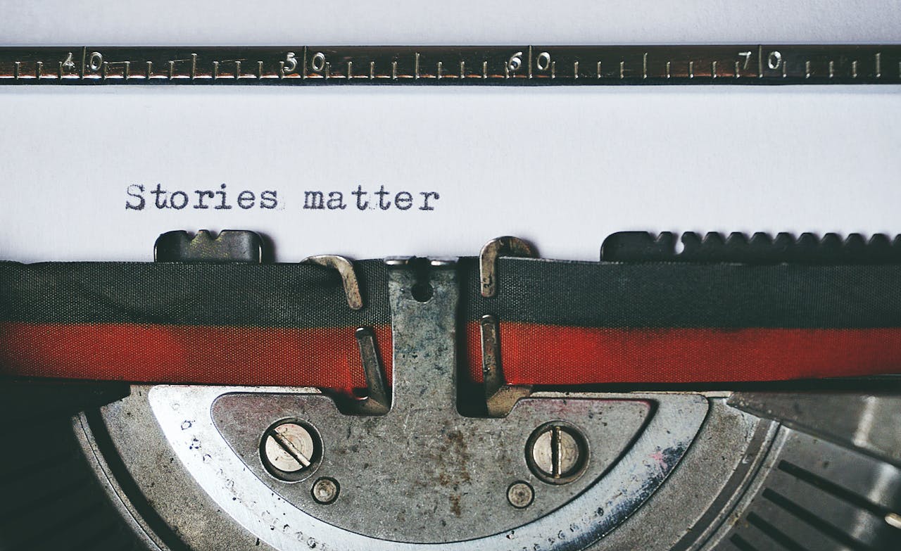 hero-img-01 Close-up of a vintage typewriter with the text 'Stories matter' typed on paper, evoking nostalgia.